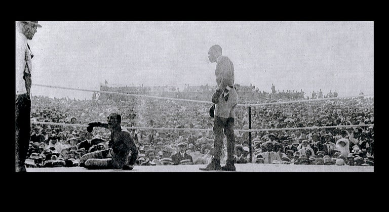 Item #4078 [Boxing] Image of Jack Johnson Standing over Jim Jeffries in 1910 World Heavyweight Fight in Reno, Nevada. Dana Studios?, Uncredited Photographer.